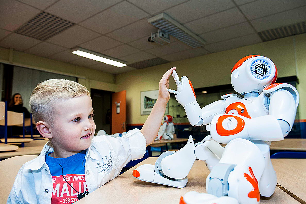 Barn gör high-five med robot